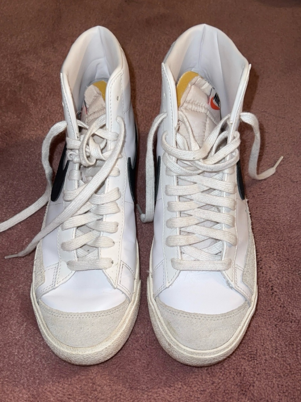 Nike White High-Top Sneakers with Black Swoosh and Yellow Tongue Tab